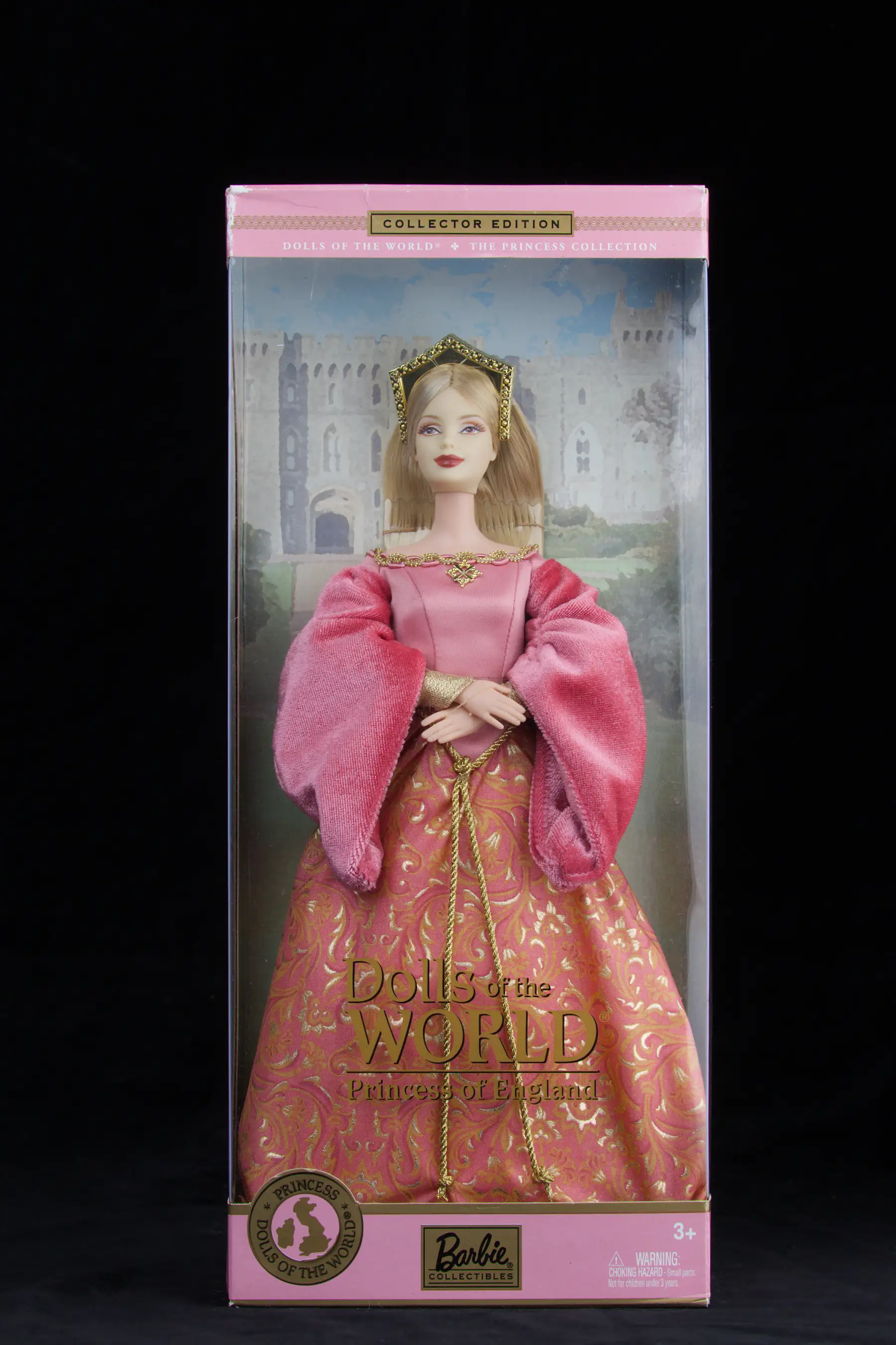A boxed Dolls of the World Barbie, Princess of England, in a pink and gold gown and gold tiara against a painted castle backdrop